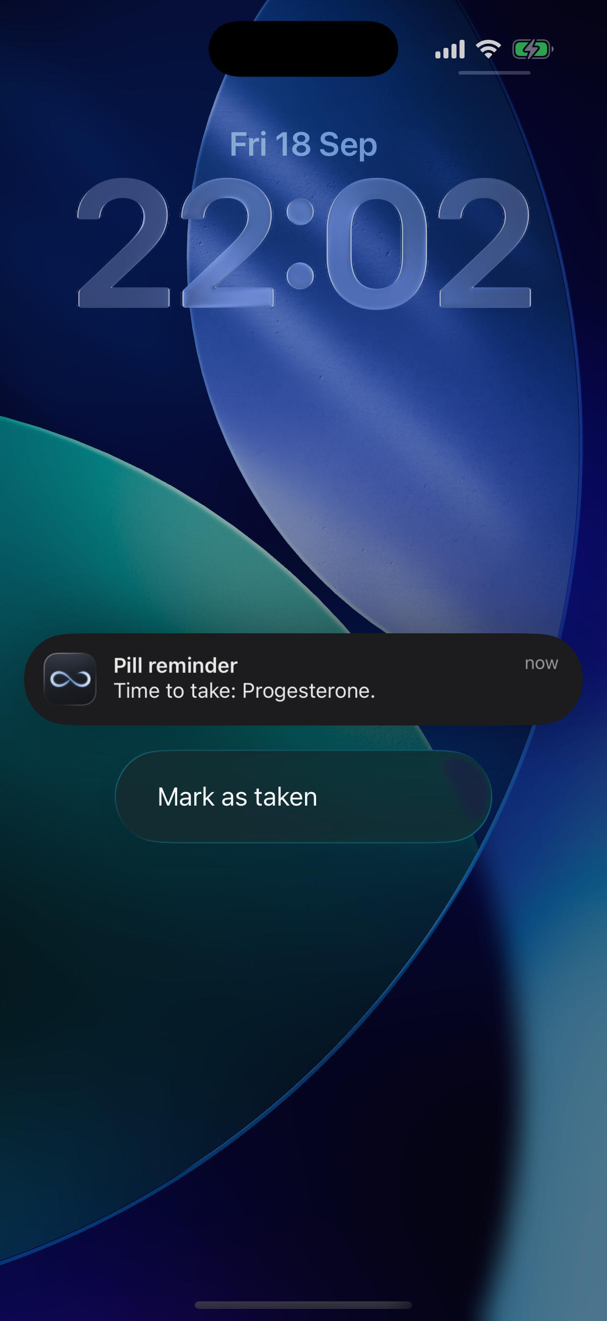 iPhone lock screen with a Pill reminder notification for Progesterone and an expanded Mark as taken button
